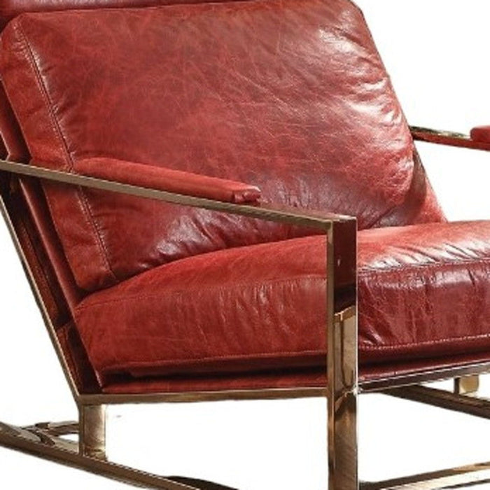 Red top grain leather lounge chair with gold accents and matching ottoman, stylish stationary chair for modern living spaces.