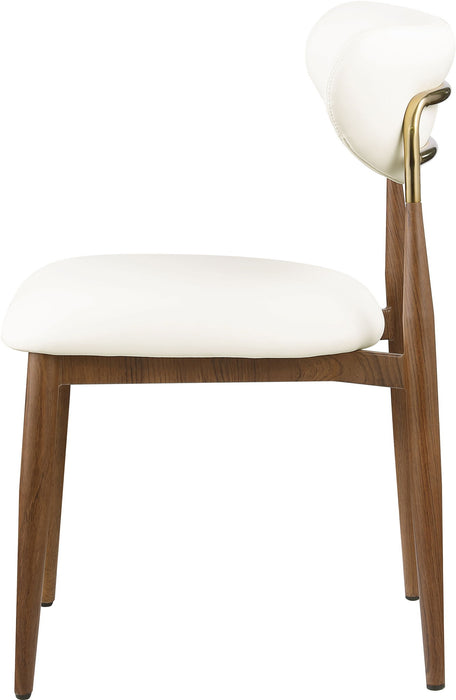 Vegan leather upholstered Meridian Furniture Ronda dining side chair with walnut wood legs, modern design and comfortable seating.