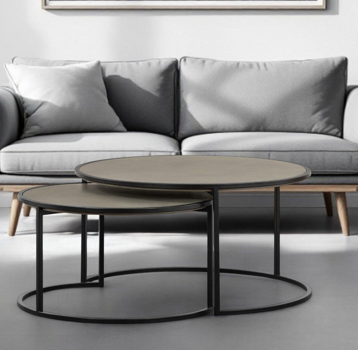 HomeRoots concrete and metal round nesting coffee tables set in gray and black, featuring modern, minimalist design.
