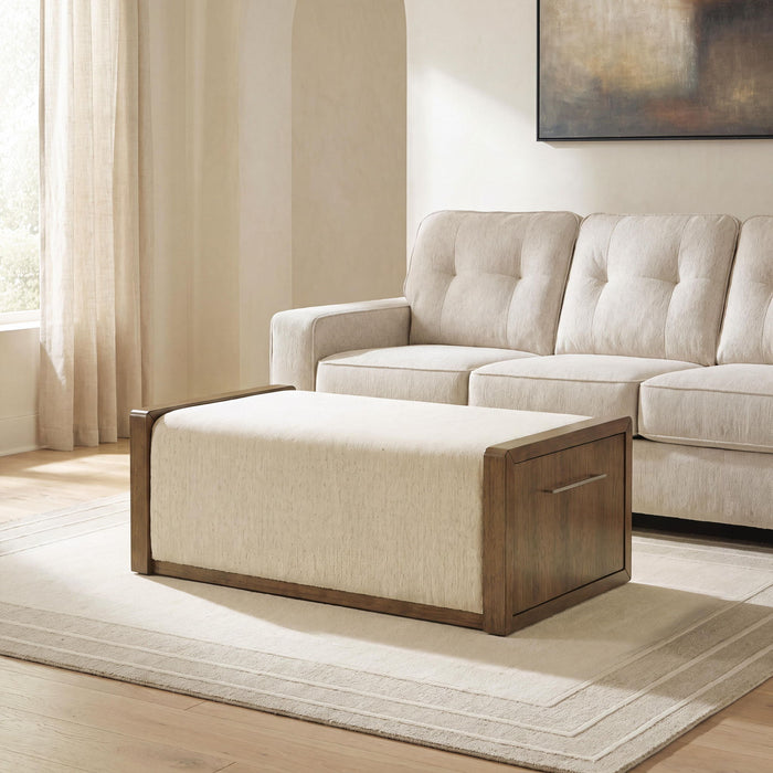 Brown upholstered storage ottoman by Signature Design by Ashley®, featuring a cushioned top and hidden storage compartment.