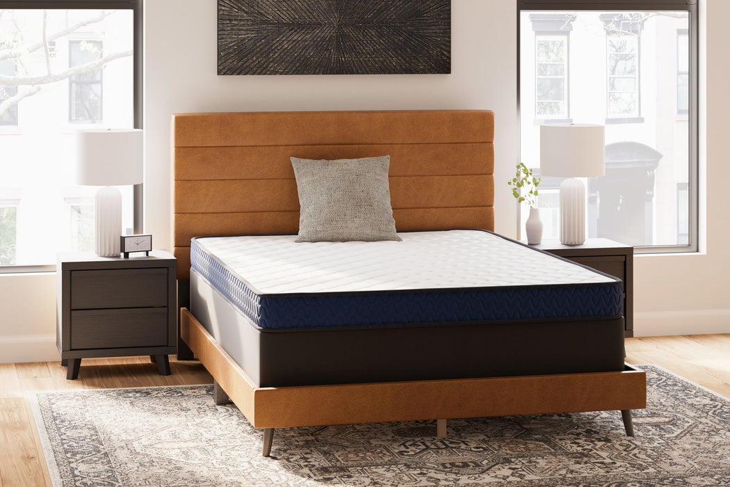 Sierra Sleep® Ashley Firm Memory Foam Mattress with plush surface and supportive layers, shown in a modern bedroom setting.