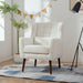 Giga modern accent armchair with soft upholstery, wooden legs, and pillow, ideal for living room or bedroom seating.
