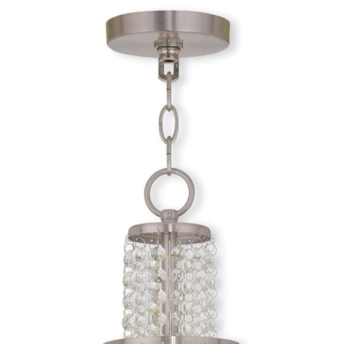 HomeRoots 20-inch three-light metal chandelier with shades, dimmable, featuring nickel finish and clear/off white shades.