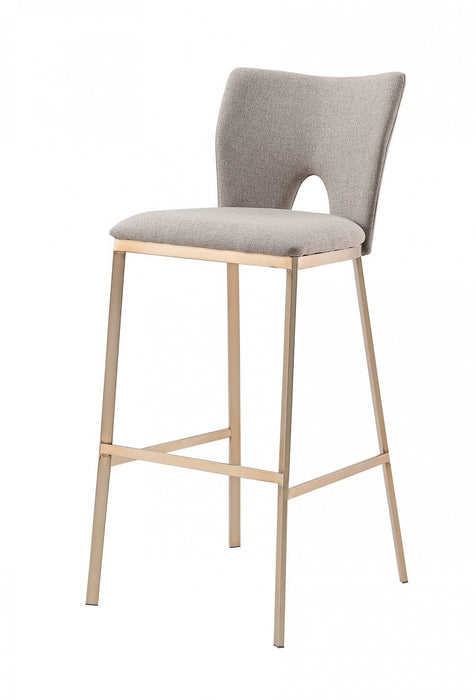 Set of two iron bar height chairs by HomeRoots with gray seats and antiqued brass frames, perfect for modern kitchen or bar area.