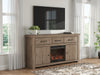 Signature Design by Ashley Garistyn TV stand with built-in fireplace, wood finish, and storage compartments for modern living room decor.