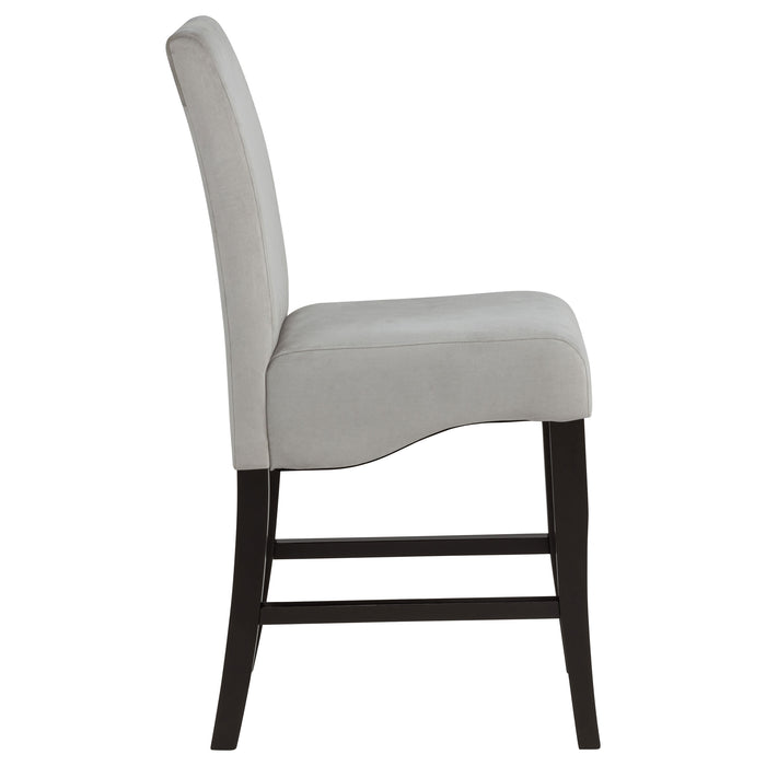 Set of two CoasterEssence Stanton velvet upholstered counter chairs in grey with plush, tufted seats and sleek wooden legs.