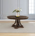 Dark oak Ridgewell round pedestal dining table by CoasterEveryday, showcasing smooth wood surface and sturdy pedestal base.