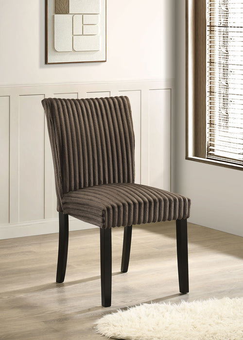 Two CoasterEveryday Dermott upholstered Parson dining side chairs in chocolate fabric, showing their tufted backs and wooden legs.