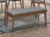 Alfredo upholstered dining bench in grey and natural walnut finish, featuring a padded seat and wooden legs for contemporary dining room.