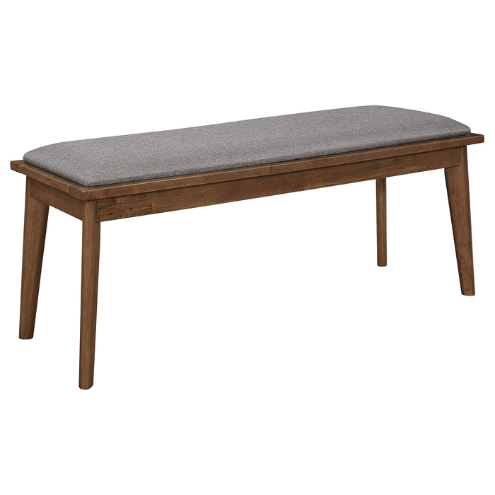 Alfredo upholstered dining bench by CoasterEveryday with grey fabric and natural walnut wooden legs, ideal for modern dining rooms.