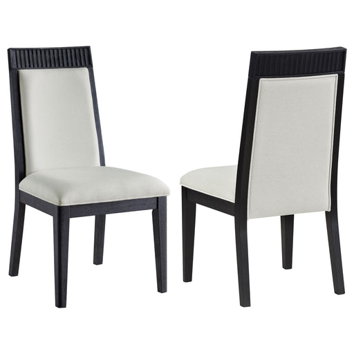 Set of two Brookmead dining side chairs by CoasterEveryday with ivory and black upholstered seats and sleek black legs.