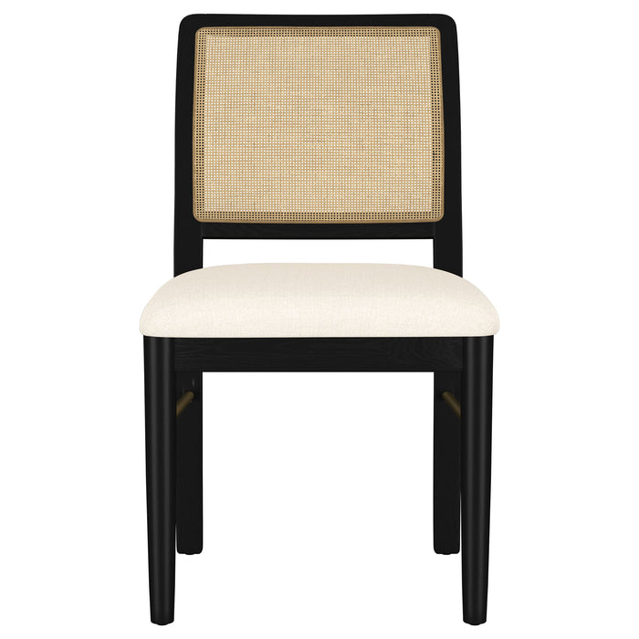 CoasterEveryday Arini 5-piece round dining table set with sand wash finish and black legs, showing the table and chairs in a modern dining room.