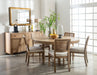 CoasterEveryday Arini 60-inch round wood dining table in sand wash finish, showcasing smooth wooden surface and sturdy legs.