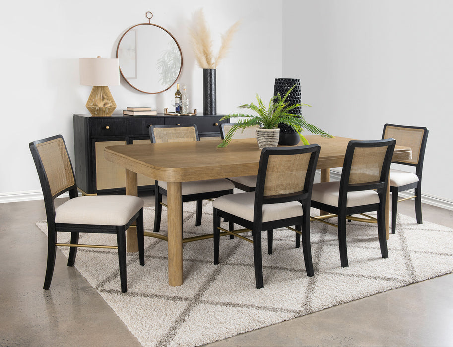CoasterEveryday Arini 7-piece extension leaf dining table set in sand wash and black with matching chairs and table leaves.