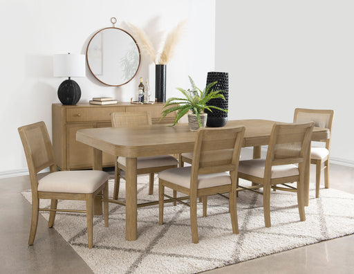 CoasterEveryday Arini 7-piece extension leaf dining table set in sand wash wood finish with matching chairs and extension leaf.