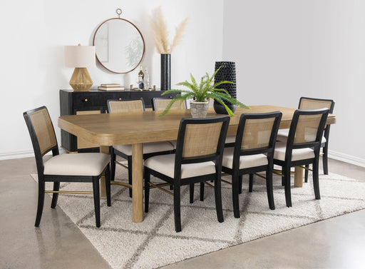 CoasterEveryday Arini 9-piece extension leaf dining table set with sand wash and black finish, showing table and chairs.