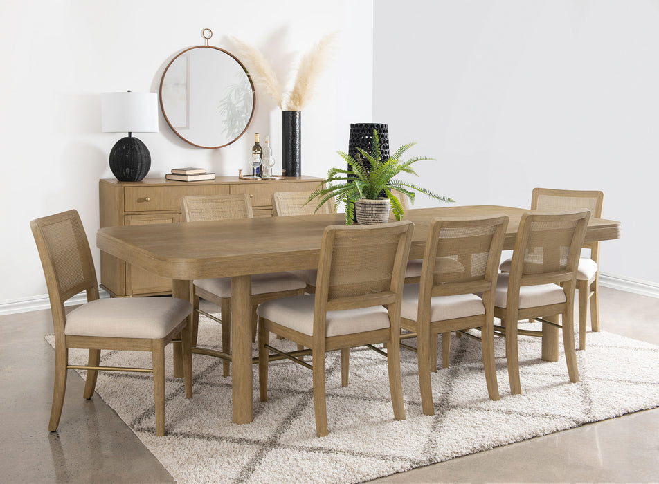 CoasterEveryday Arini 104-inch extension leaf dining table in sand wash with smooth surface and sturdy wooden construction.