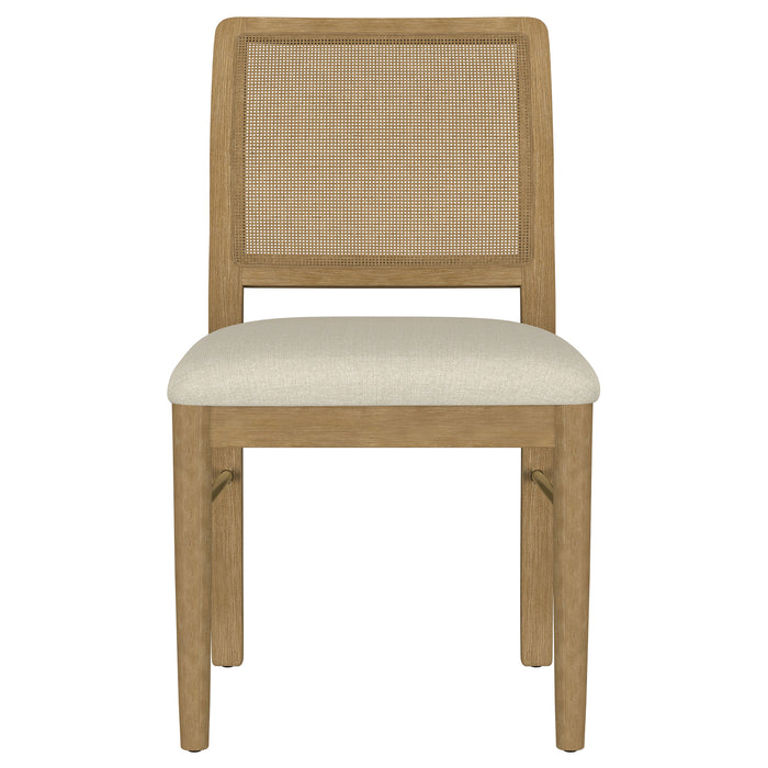Set of two Arini Rattan Cane Dining Side Chairs in Sand Wash finish with woven cane seats and curved backs.
