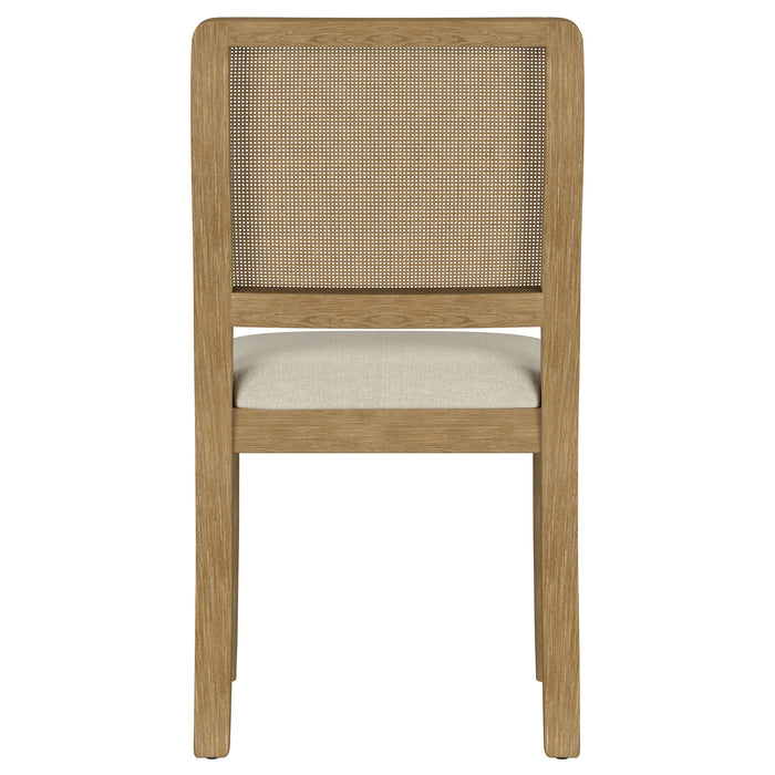 Two Arini Rattan Cane Dining Side Chairs in Sand Wash finish with woven rattan seats, showcasing their stylish, natural wood design.