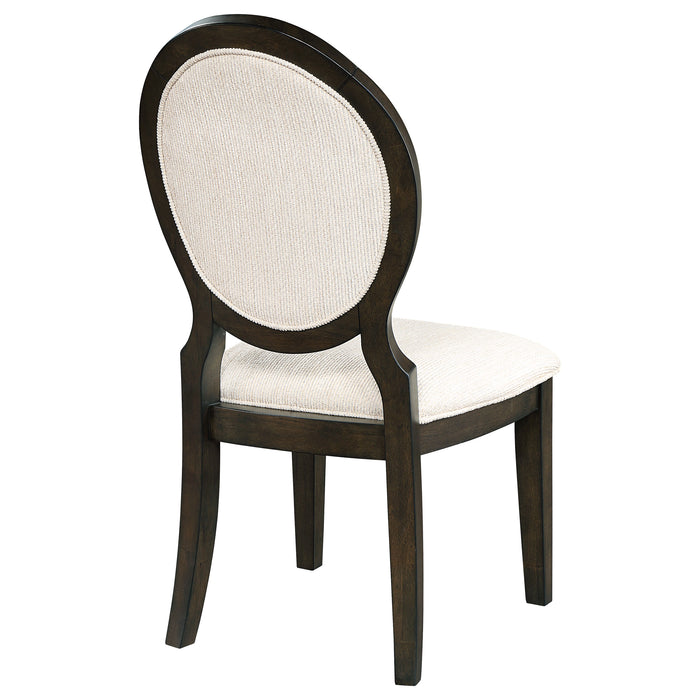 Two dark cocoa Twyla oval back dining side chairs by CoasterEssence, featuring wooden legs and upholstered seats.
