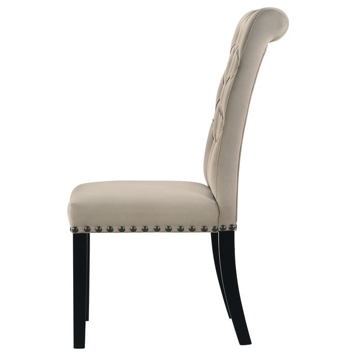 Set of two CoasterEssence Alana velvet upholstered dining side chairs in sand color, featuring padded seats and sleek wooden legs.