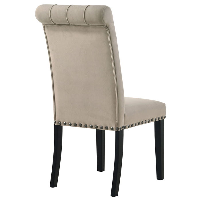 Pair of CoasterEssence Alana velvet upholstered dining side chairs in sand color, featuring padded seats and sleek wooden legs.