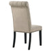 Pair of CoasterEssence Alana velvet upholstered dining side chairs in sand color, featuring padded seats and sleek wooden legs.