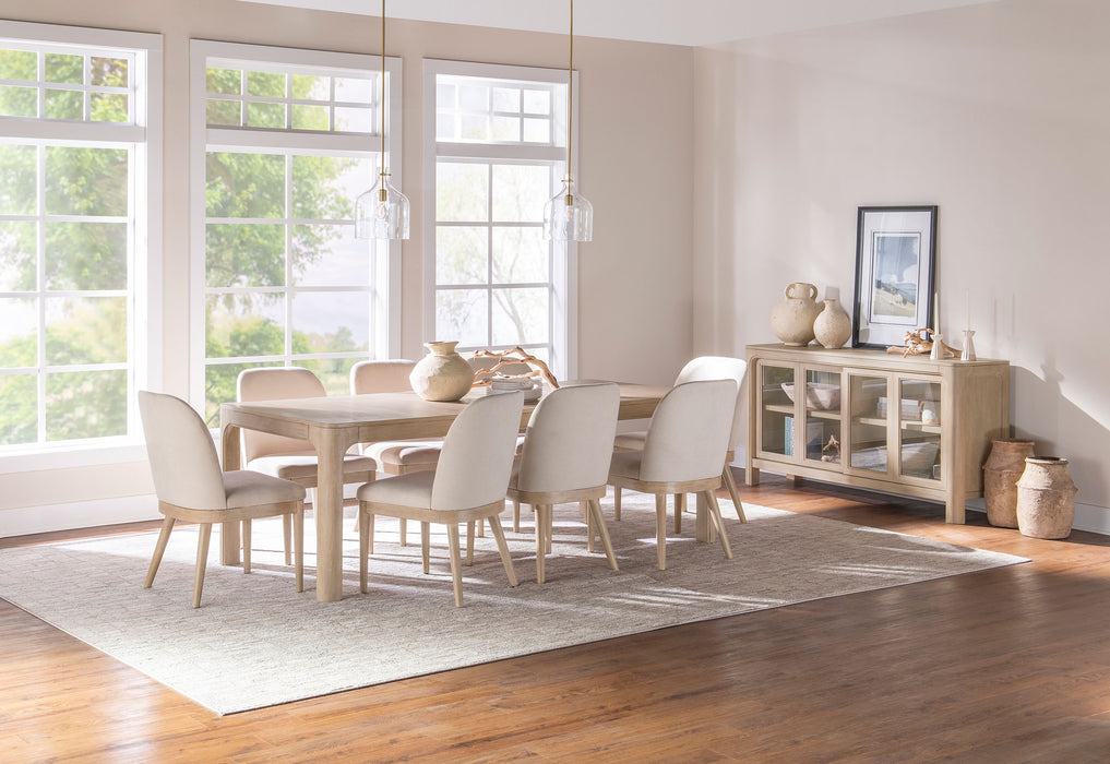 Pair of beige Solano upholstered dining side chairs by CoasterEveryday, featuring cushioned seats and wooden legs for comfortable dining.