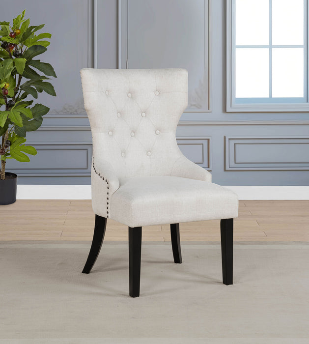 Cream and black Baney fabric upholstered dining side chair with wooden legs from CoasterEveryday, shown from a side angle.