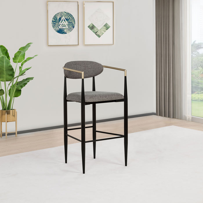 Pair of grey Tina fabric upholstered bar chairs by CoasterEveryday with wooden legs and cushioned seats.
