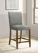 Set of two grey CoasterEveryday Paxton upholstered counter height dining chairs with cushioned seats and wooden legs.