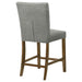 Pair of grey upholstered CoasterEveryday counter height dining chairs with wooden legs, showcasing their plush seats and modern design.