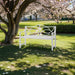 White Giga outdoor garden patio bench with slatted seat, backrest, and armrests, accommodates 2-3 people for yard or porch use.