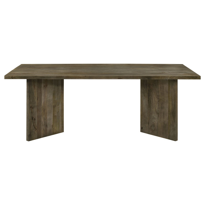CoasterEveryday Tyler 80-inch solid wood dining table in mango brown with a sleek, sturdy design and natural wood grain finish.