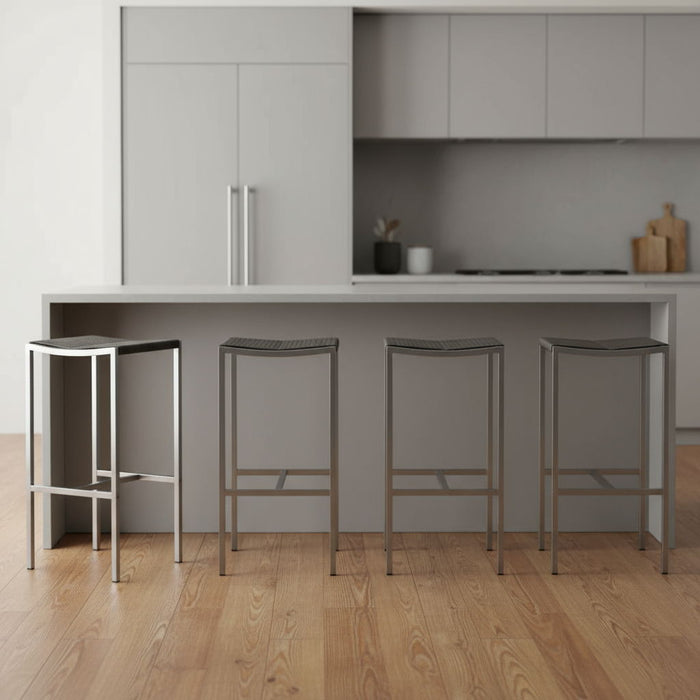 Set of four stainless steel backless bar height stools with brown seats and silver legs, ideal for kitchen or bar area.