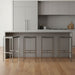 Set of four stainless steel backless bar height stools with brown seats and silver legs, ideal for kitchen or bar area.