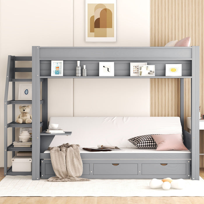 Gray Giga wood full size convertible bunk bed with storage staircase, bedside table, and three drawers, showcasing its functional design.