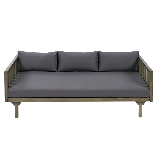 Gray Giga Claremont 3-seater daybed with slat paneling and water-resistant cushions, shown with plush seating and decorative pillows.