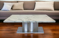 White and silver 51-inch marble and stainless steel pedestal coffee table by HomeRoots with sleek modern design.