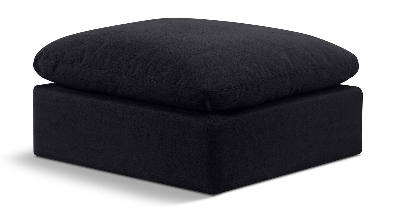 Linen upholstered Meridian Furniture Indulge ottoman with plush cushioning and modern design for living room decor