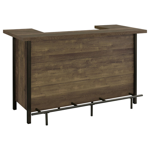 Rustic oak Bellemore freestanding home bar wine cabinet by CoasterEssence with storage shelves and wine rack in a cozy living space.