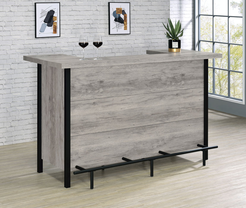 Grey driftwood Bellemore freestanding home bar wine cabinet by CoasterEssence, featuring glass doors and storage shelves for wine bottles and glasses.