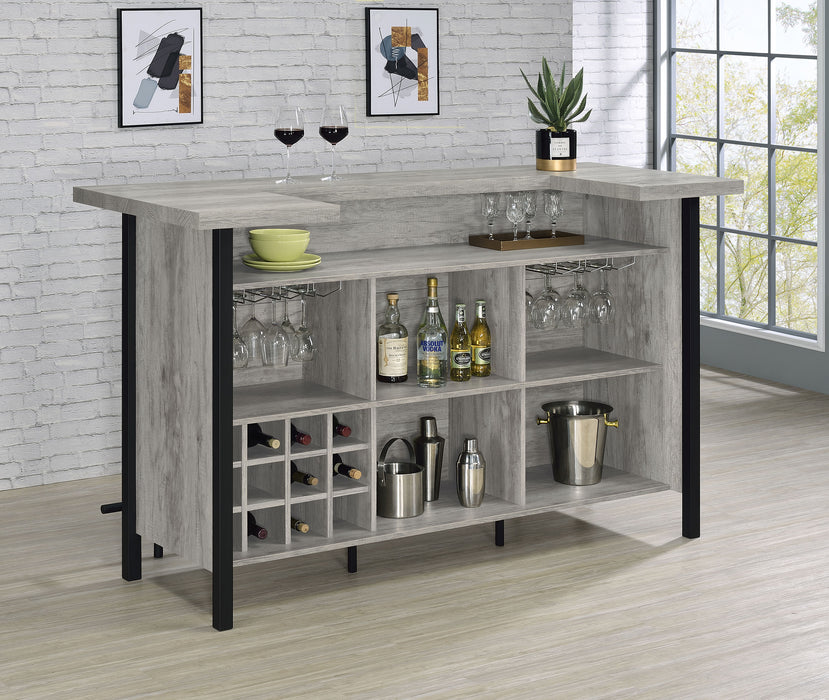 Grey driftwood Bellemore freestanding home bar wine cabinet by CoasterEssence featuring storage shelves and a sleek furniture design.