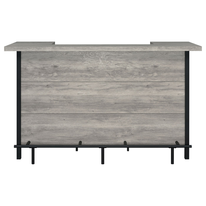 CoasterEssence Bellemore freestanding home bar wine cabinet in grey driftwood with shelves and storage compartments.