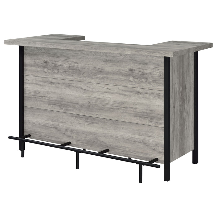 Grey driftwood Bellemore freestanding home bar wine cabinet by CoasterEssence, showing storage shelves and wine bottle compartments.