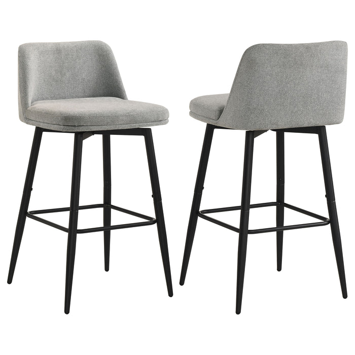 Two grey Mellor fabric upholstered swivel bar chairs with metal bases, showing the plush cushioned seats and sleek design.