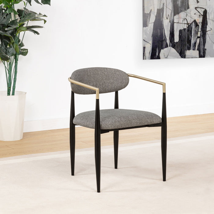 Pair of grey CoasterEveryday Bradbury fabric upholstered dining arm chairs with cushioned seats and wooden legs.