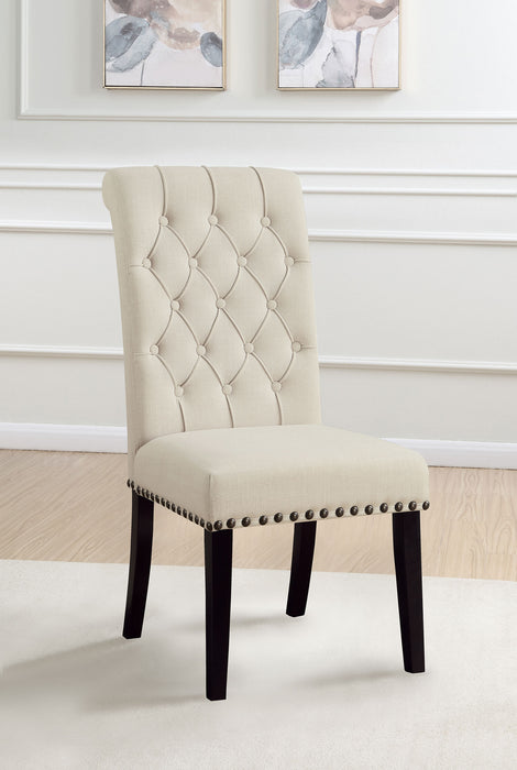 Set of two beige Alana fabric upholstered dining side chairs by CoasterEveryday with wooden legs, shown in a modern dining room setting.