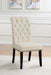 Set of two beige Alana fabric upholstered dining side chairs by CoasterEveryday with wooden legs, shown in a modern dining room setting.