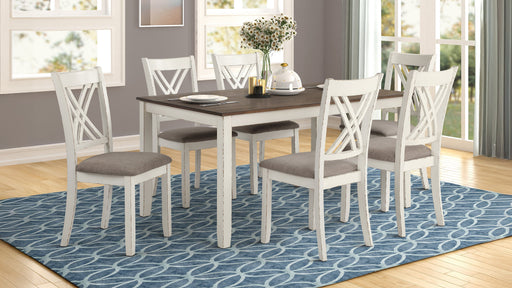 Fortress 7-piece rectangular dining set in vintage vanilla with matching chairs, featuring a wooden table and upholstered seats.